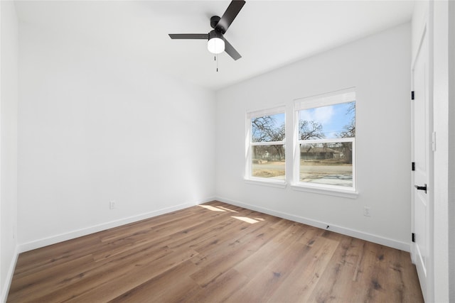 unfurnished bedroom featuring baseboards, light wood-style flooring, and a ceiling fan