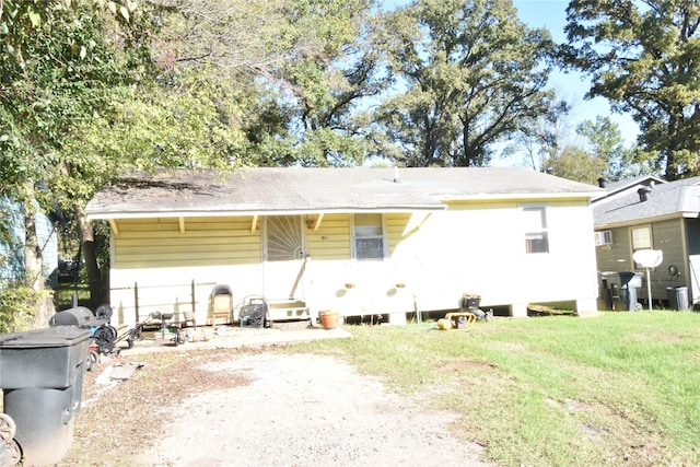 back of house with a lawn