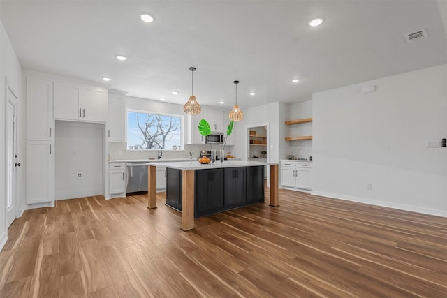 kitchen featuring visible vents, white cabinets, appliances with stainless steel finishes, and light countertops