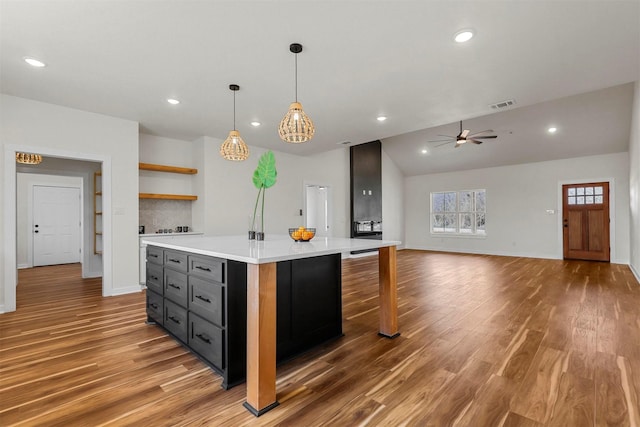 kitchen featuring visible vents, light wood-type flooring, light countertops, and open shelves