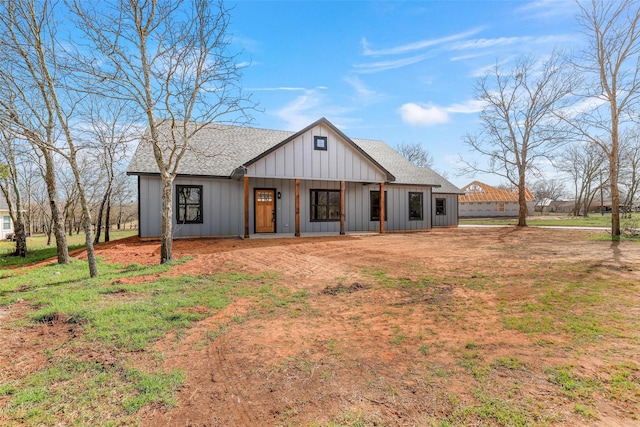 modern farmhouse style home with board and batten siding and a shingled roof