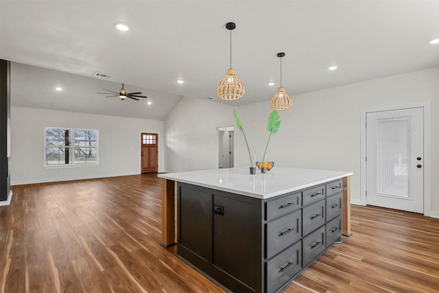 kitchen featuring a kitchen island, light countertops, recessed lighting, wood finished floors, and a ceiling fan