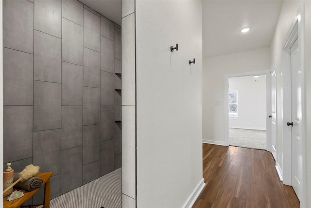 hall with recessed lighting, baseboards, and dark wood-type flooring