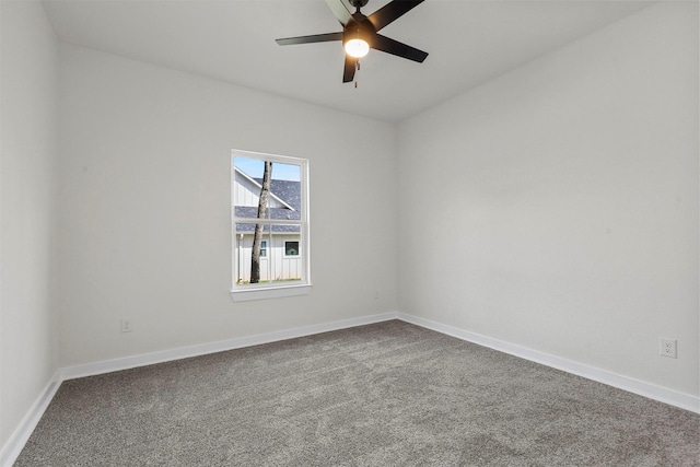 spare room with a ceiling fan, baseboards, and carpet floors