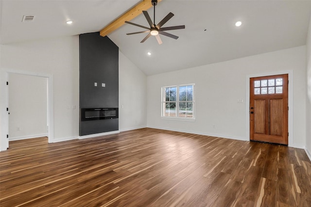 unfurnished living room with a glass covered fireplace, beam ceiling, dark wood finished floors, and visible vents