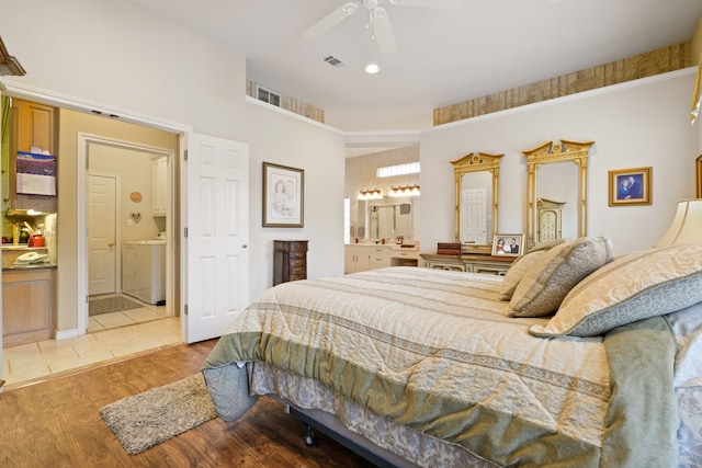 bedroom with ceiling fan, visible vents, light wood-style flooring, and ensuite bathroom