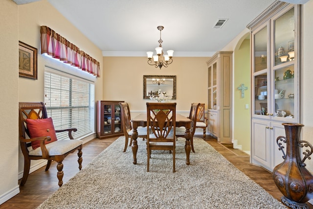 dining room with visible vents, baseboards, a notable chandelier, and dark wood-style floors