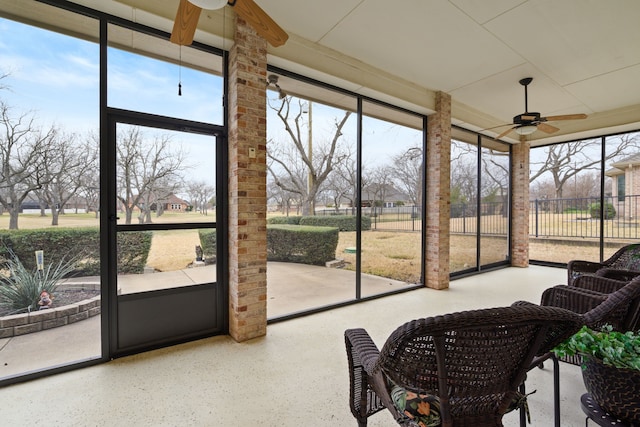 sunroom featuring a healthy amount of sunlight and a ceiling fan