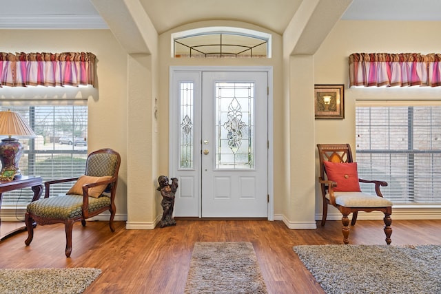 entryway with baseboards and wood finished floors