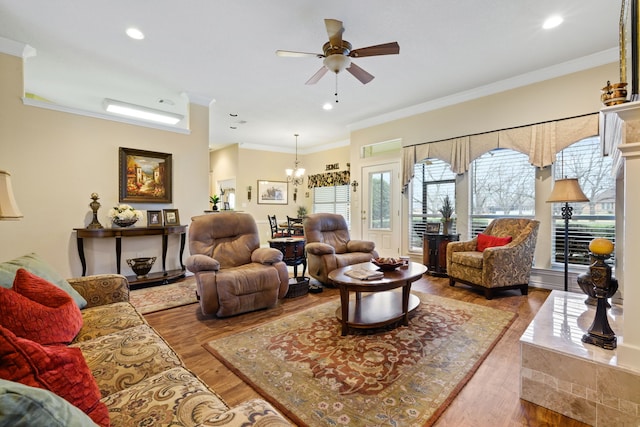 living room with recessed lighting, wood finished floors, crown molding, and ceiling fan with notable chandelier