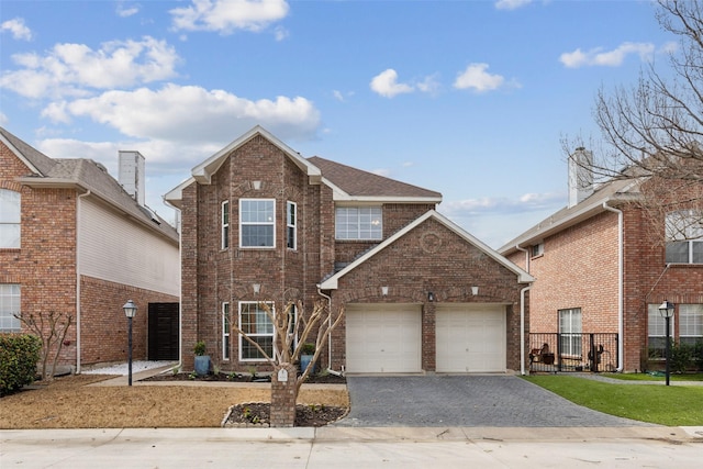 traditional-style home with an attached garage, brick siding, driveway, and roof with shingles