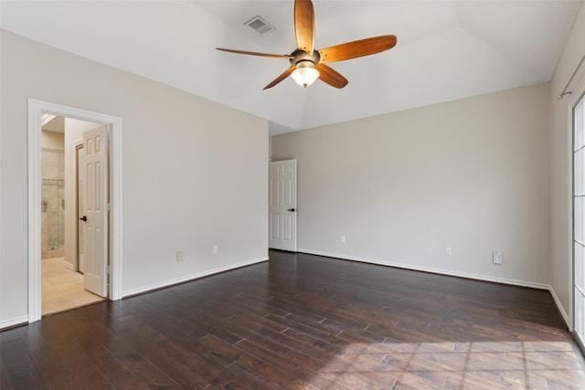 empty room with visible vents, baseboards, dark wood-type flooring, and a ceiling fan