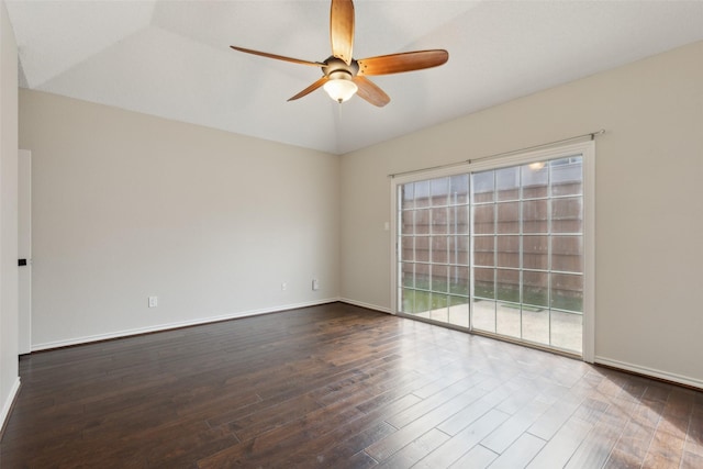 empty room featuring vaulted ceiling, a ceiling fan, dark wood-type flooring, and baseboards