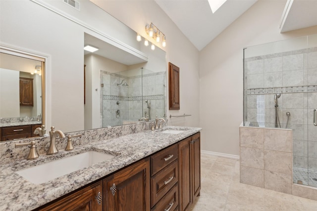 bathroom with visible vents, a stall shower, and a sink