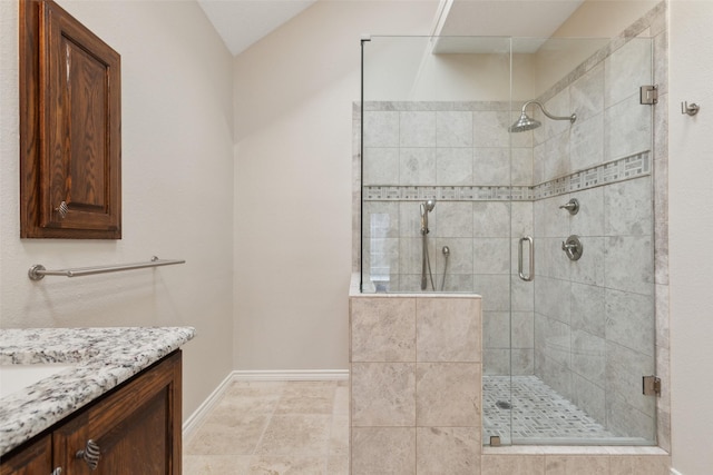 full bathroom featuring a shower stall, vanity, and baseboards