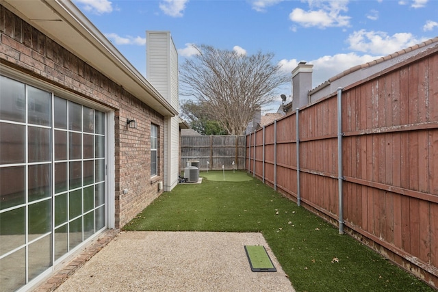 view of yard with cooling unit and a fenced backyard