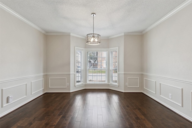 unfurnished dining area featuring dark wood finished floors, an inviting chandelier, a decorative wall, and a textured ceiling