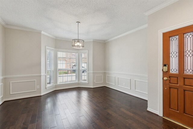 entrance foyer with a notable chandelier, a textured ceiling, and dark wood-style flooring