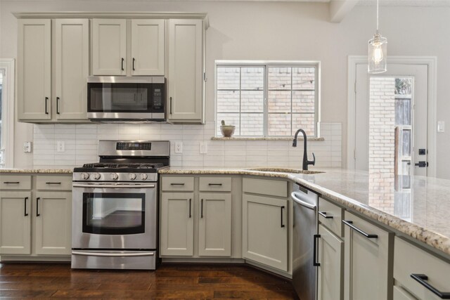 kitchen featuring a sink, dark wood finished floors, a wealth of natural light, and stainless steel appliances