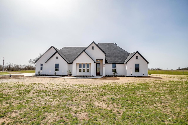 modern farmhouse style home with a shingled roof and stucco siding