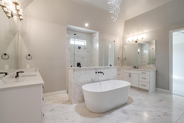 bathroom featuring vaulted ceiling, marble finish floor, a marble finish shower, and a sink