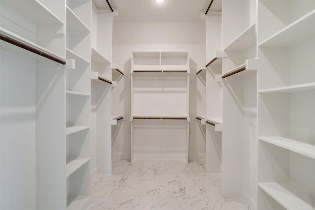 spacious closet featuring marble finish floor