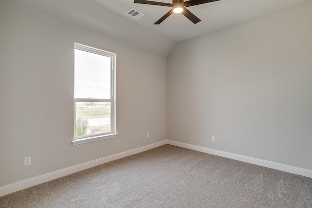 spare room with visible vents, baseboards, lofted ceiling, carpet flooring, and a ceiling fan