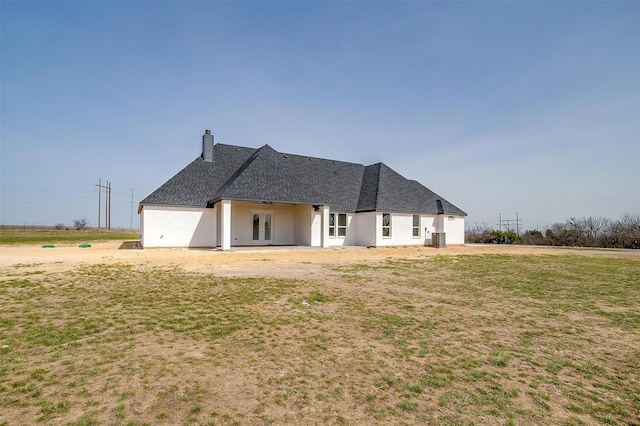 rear view of property with french doors and a chimney