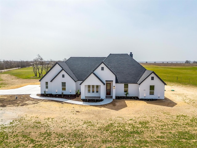 view of front of house with roof with shingles and stucco siding