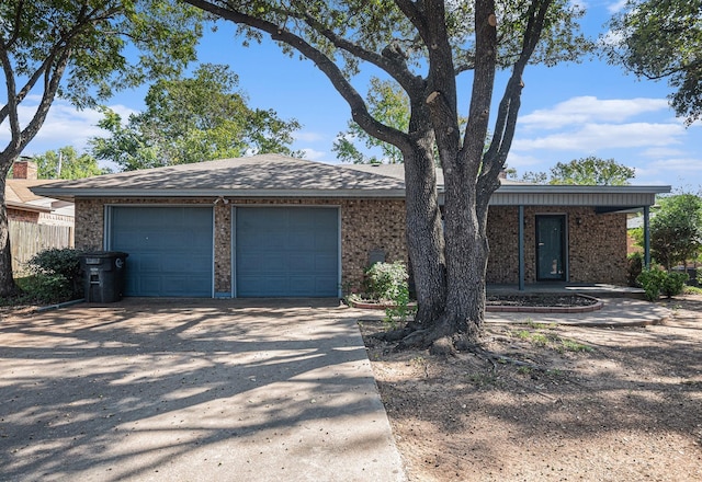 view of front of home featuring an attached garage, fence, and driveway