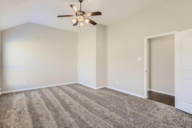 empty room featuring carpet floors, ceiling fan, baseboards, and vaulted ceiling