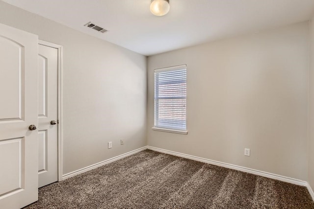 carpeted empty room with visible vents and baseboards