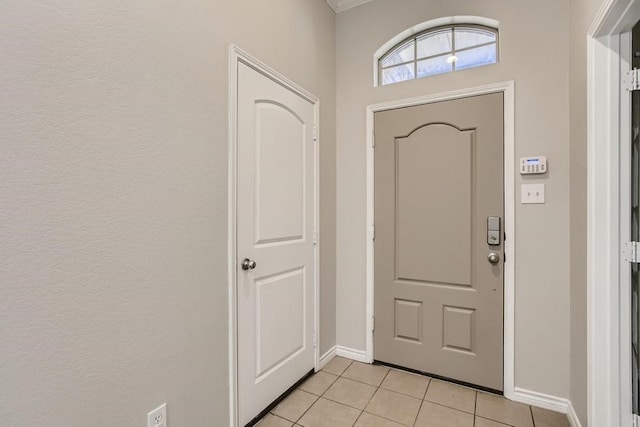 entrance foyer with light tile patterned floors and baseboards