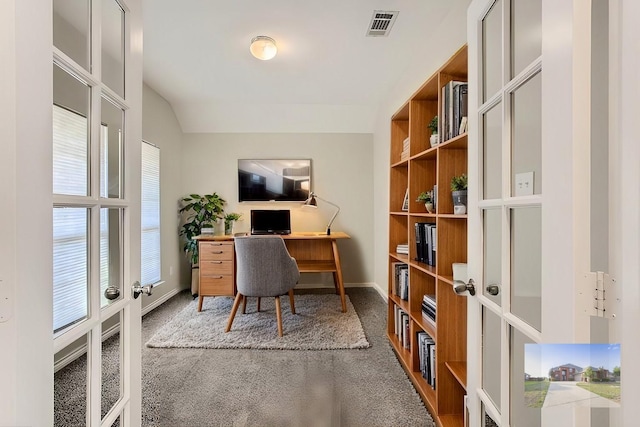 home office featuring carpet, vaulted ceiling, french doors, and visible vents