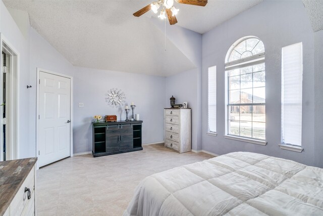 bedroom featuring vaulted ceiling, multiple windows, baseboards, and ceiling fan