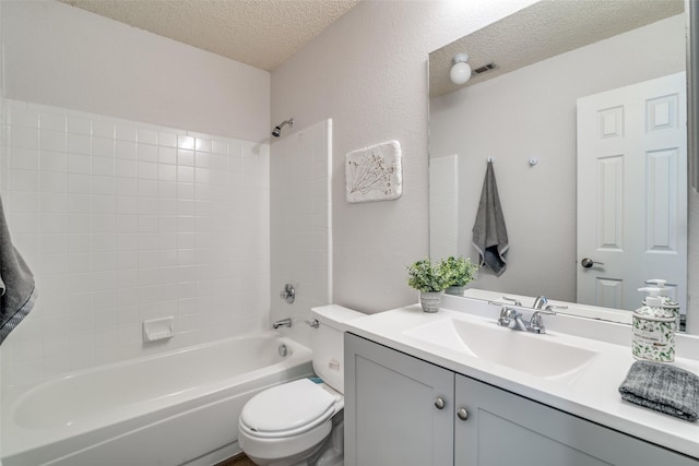 bathroom featuring vanity, visible vents, a textured ceiling, shower / bathing tub combination, and toilet