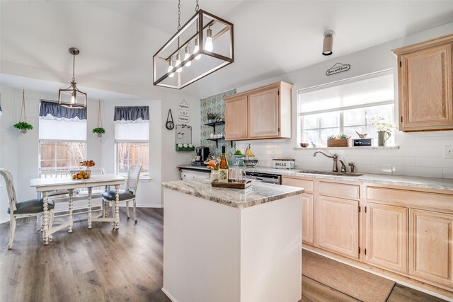 kitchen with a sink, backsplash, a wealth of natural light, and light brown cabinets