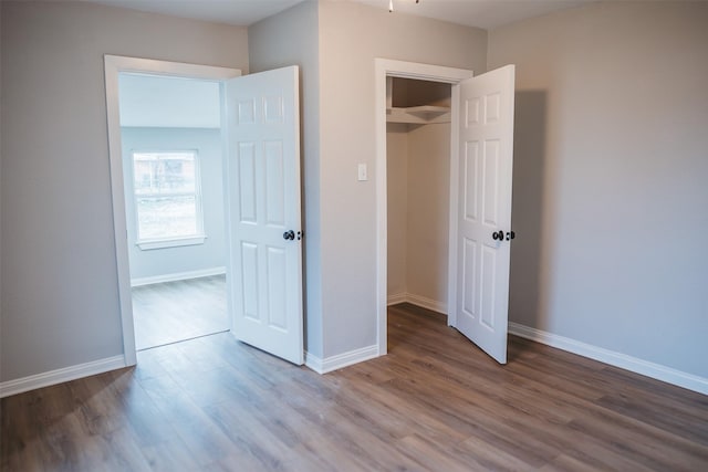 unfurnished bedroom featuring baseboards and wood finished floors