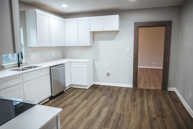 kitchen with stainless steel dishwasher, white cabinets, dark wood-style floors, and a sink