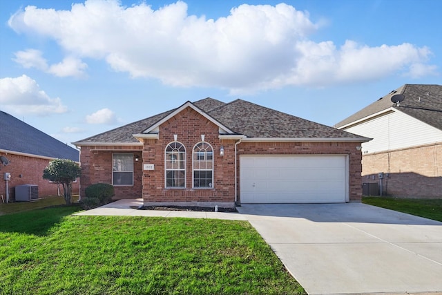 ranch-style house featuring driveway, roof with shingles, a front yard, brick siding, and central AC unit