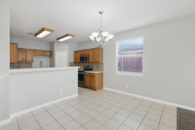 kitchen with an inviting chandelier, light countertops, brown cabinets, and stainless steel appliances