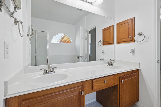 full bathroom featuring a sink, visible vents, an enclosed shower, and double vanity