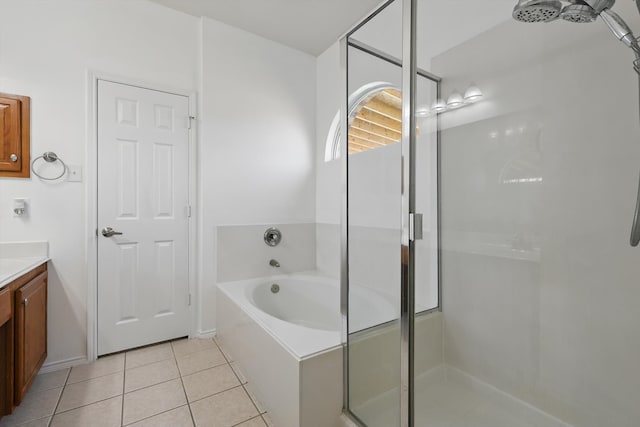 full bath with vanity, a shower stall, a garden tub, and tile patterned flooring