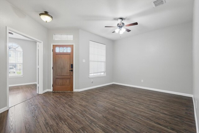 entryway featuring dark wood-style floors, visible vents, a healthy amount of sunlight, and baseboards