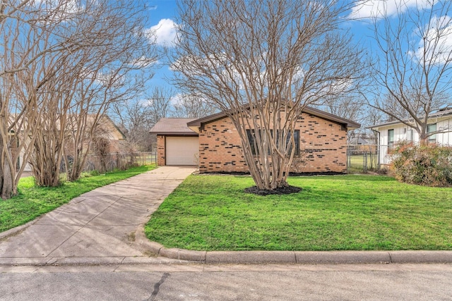 view of front of house featuring driveway, fence, a front yard, a garage, and brick siding