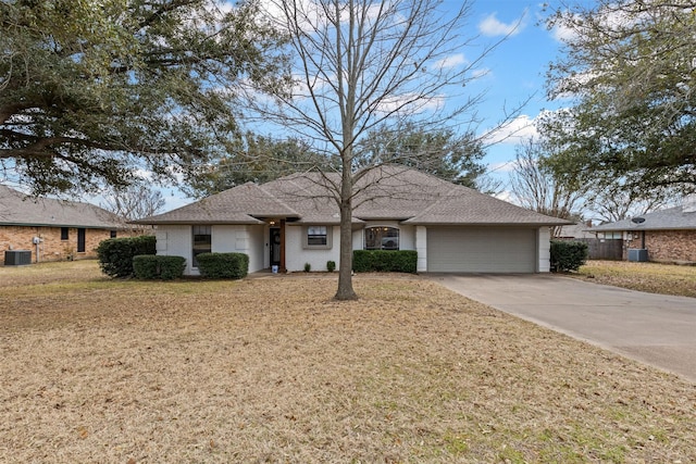 single story home featuring brick siding, an attached garage, a front lawn, central air condition unit, and driveway