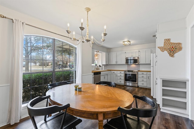 dining room with a chandelier and dark wood-style flooring