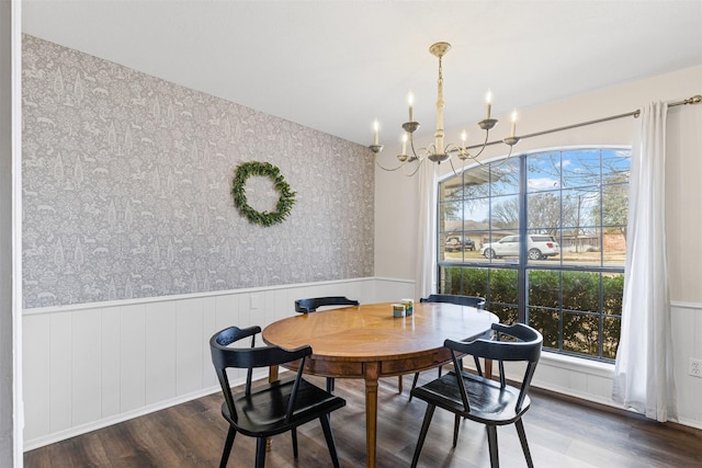 dining space featuring a wainscoted wall, a healthy amount of sunlight, wood finished floors, and wallpapered walls