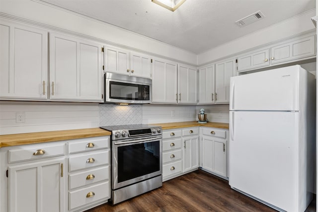 kitchen featuring tasteful backsplash, visible vents, appliances with stainless steel finishes, wood counters, and dark wood-style flooring