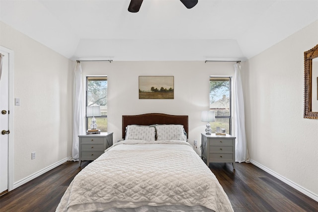 bedroom featuring dark wood finished floors, vaulted ceiling, a ceiling fan, and baseboards